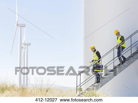 Workers on wind turbine in rural landscape View Large Photo Image Stock Photo - Workers on wind turbine in rural landscape. Fotosearch