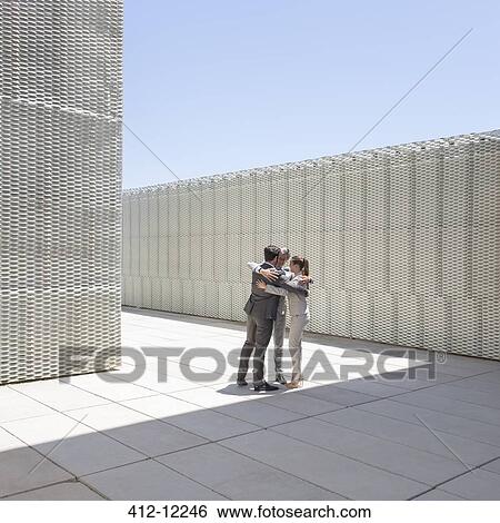 Business people hugging outdoors View Large Photo Image Stock Photograph - Business people hugging outdoors. Fotosearch