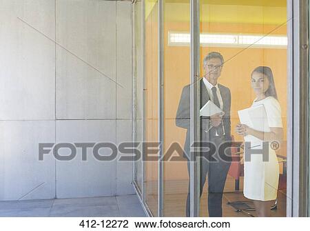 Business people smiling at office window View Large Photo Image Stock Image - Business people smiling at office window. Fotosearch