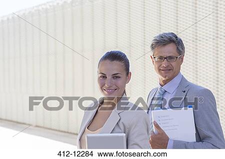 Business people smiling outdoors View Large Photo Image Picture - Business people smiling outdoors. Fotosearch