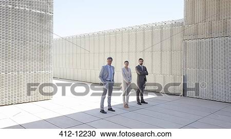 Stock Image - Business people standing outdoors. Fotosearch