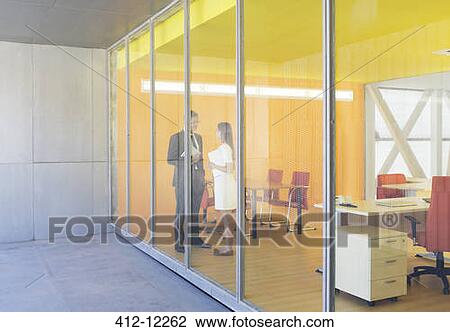 Stock Image - Business people talking in office. Fotosearch