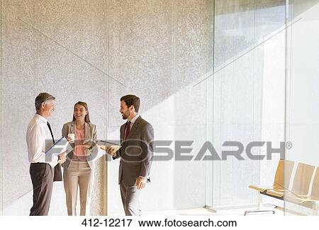 Stock Photo - Business people talking in office. Fotosearch