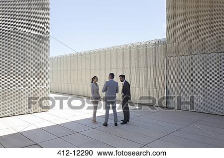 Business people talking outdoors View Large Photo Image Stock Image - Business people talking outdoors. Fotosearch