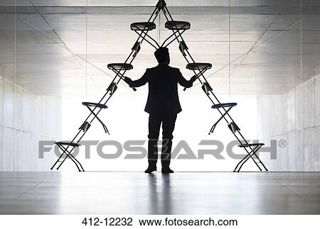 Businessman arranging office chair installation art View Large Photo Image Stock Image - Businessman arranging office chair installation art. Fotosearch