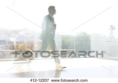 Businessman running in sunny airport View Large Photo Image Stock Photo - Businessman running in sunny airport. Fotosearch