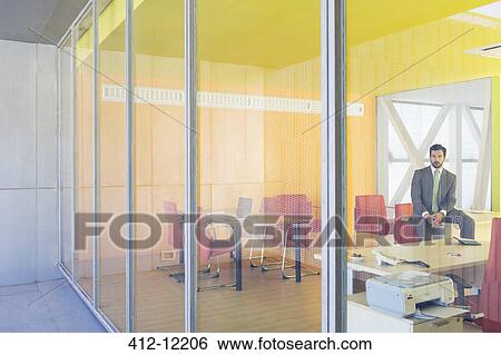 Businessman sitting in office View Large Photo Image Stock Photograph - Businessman sitting in office. Fotosearch