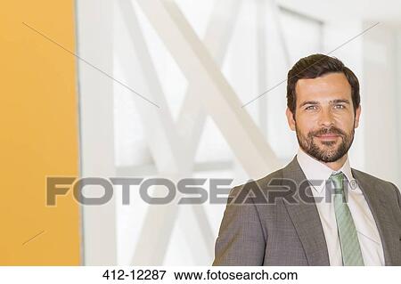 Stock Photo - Businessman smiling in office. Fotosearch