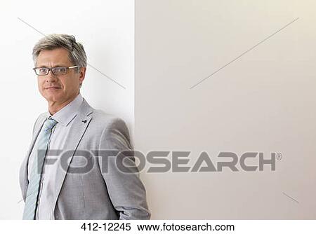 Businessman smiling in office View Large Photo Image Stock Photography - Businessman smiling in office. Fotosearch