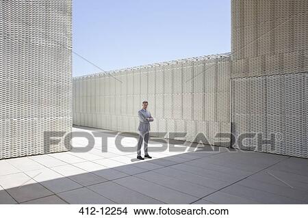 Picture - Businessman standing outdoors. Fotosearch