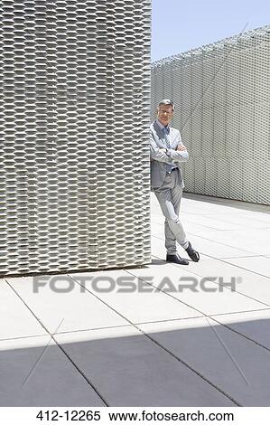 Stock Photography - Businessman standing outdoors. Fotosearch
