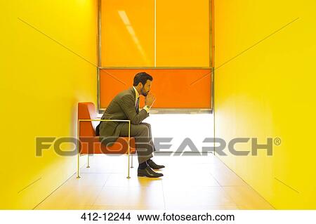 Businessman thinking in bright office View Large Photo Image Picture - Businessman thinking in bright office. Fotosearch