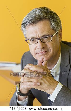 Stock Photo - Businessman with hands clasped. Fotosearch