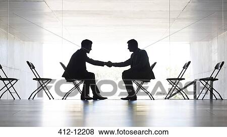 Businessmen shaking hands in office View Large Photo Image Stock Photo - Businessmen shaking hands in office. Fotosearch