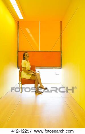 Businesswoman sitting in bright office View Large Photo Image Stock Photo - Businesswoman sitting in bright office. Fotosearch