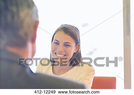 Stock Photo - Businesswoman smiling in meeting. Fotosearch