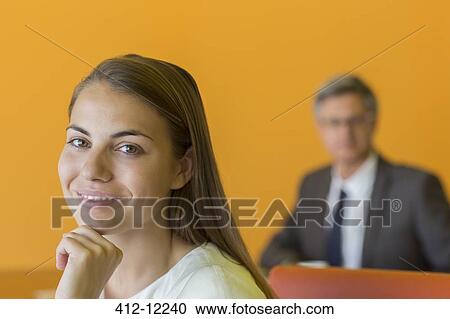 Stock Image - Businesswoman smiling in office. Fotosearch