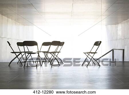 Stock Image - Empty office chairs arranged in circle. Fotosearch