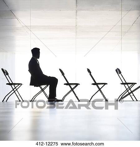 Silhouette of businessman sitting in office View Large Photo Image Stock Photography - Silhouette of businessman sitting in office. Fotosearch