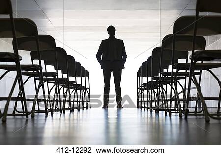 Silhouette of businessman standing in office View Large Photo Image Stock Image - Silhouette of businessman standing in office. Fotosearch