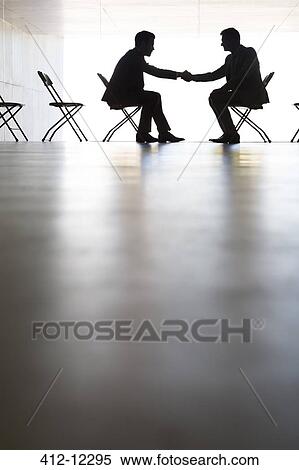 Silhouette of businessmen shaking hands in office View Large Photo Image Stock Photography - Silhouette of businessmen shaking hands in office. Fotosearch
