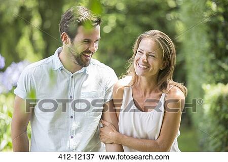 Couple walking together outdoors View Large Photo Image Stock Photo - Couple walking together outdoors. Fotosearch