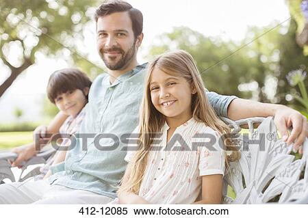 Father and children smiling on bench View Large Photo Image Stock Photography - Father and children smiling on bench. Fotosearch