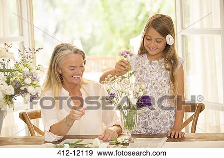 Grandmother and granddaughter arranging flowers View Large Photo Image Stock Photo - Grandmother and granddaughter arranging flowers. Fotosearch