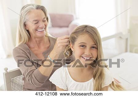 Grandmother braiding granddaughter's hair View Large Photo Image Stock Photo - Grandmother braiding granddaughter's hair. Fotosearch