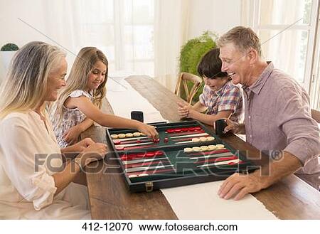 Grandparents and grandchildren playing backgammon View Large Photo Image Stock Image - Grandparents and grandchildren playing backgammon. Fotosearch