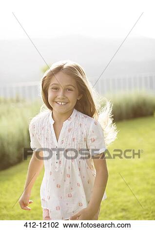 Happy girl running in grass View Large Photo Image Stock Image - Happy girl running in grass. Fotosearch
