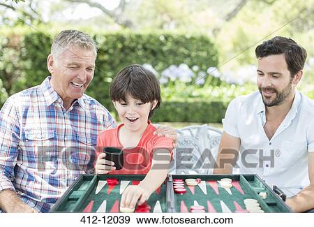Men playing backgammon outdoors View Large Photo Image Stock Photo - Men playing backgammon outdoors. Fotosearch