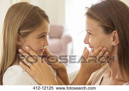 Stock Photography - Mother and daughter touching faces. Fotosearch