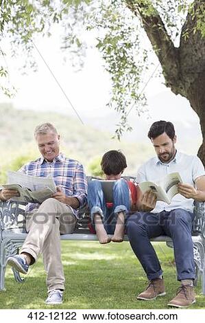 Multi-generation men reading on bench View Large Photo Image Stock Image - Multi-generation men reading on bench. Fotosearch