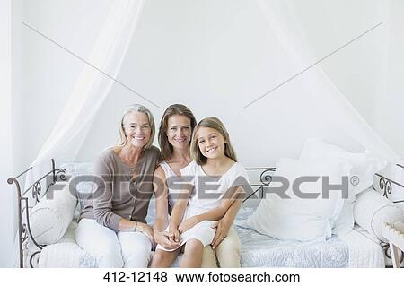 Multi-generation women smiling on daybed View Large Photo Image Stock Photo - Multi-generation women smiling on daybed. Fotosearch