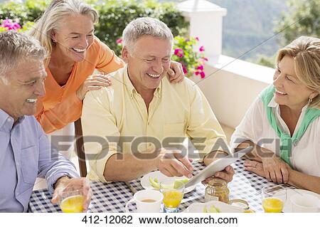 Older couples using digital tablet View Large Photo Image Stock Image - Older couples using digital tablet. Fotosearch