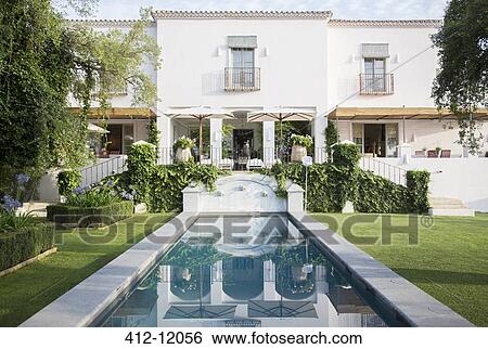 Reflecting pool in backyard of luxury home View Large Photo Image Stock Photograph - Reflecting pool in backyard of luxury home. Fotosearch
