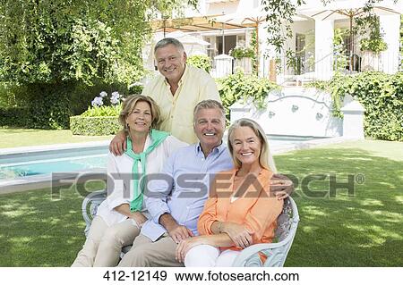 Senior couples smiling at poolside View Large Photo Image Stock Photo - Senior couples smiling at poolside. Fotosearch