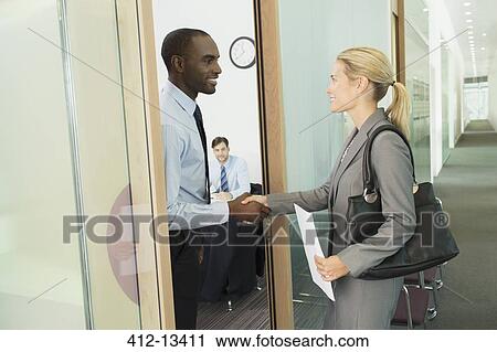 Business people shaking hands in office View Large Photo Image Stock Image - Business people shaking hands in office. Fotosearch