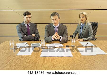 Stock Photograph - Business people sitting in meeting. Fotosearch