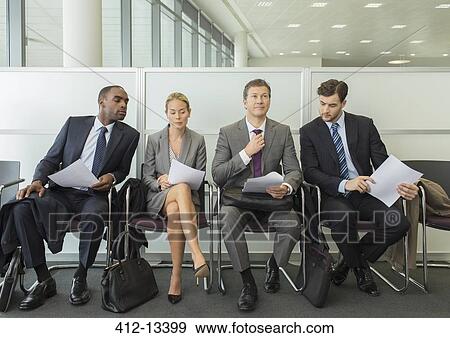 Stock Photo - Business people sitting in waiting area. Fotosearch