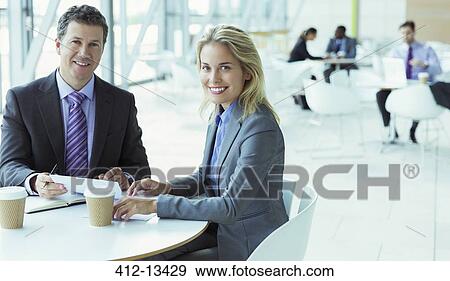 Stock Photo - Business people smiling in cafe. Fotosearch