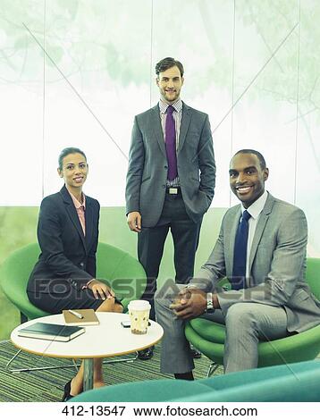 Business people smiling in office View Large Photo Image Stock Photo - Business people smiling in office. Fotosearch