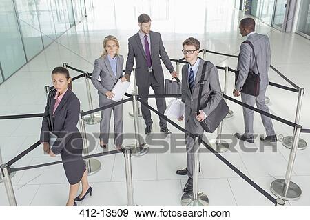 Stock Photo - Business people standing in roped-off area. Fotosearch