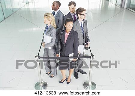 Business people standing in roped-off square View Large Photo Image Stock Photo - Business people standing in roped-off square. Fotosearch