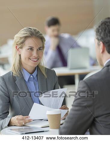 Stock Photo - Business people talking in office. Fotosearch
