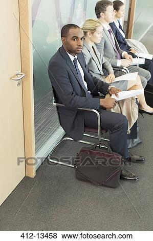 Stock Photo - Business people waiting in office. Fotosearch
