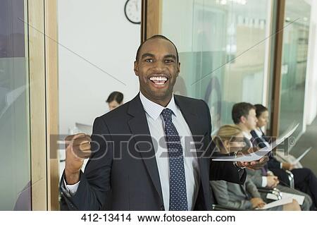 Picture - Businessman cheering in office. Fotosearch