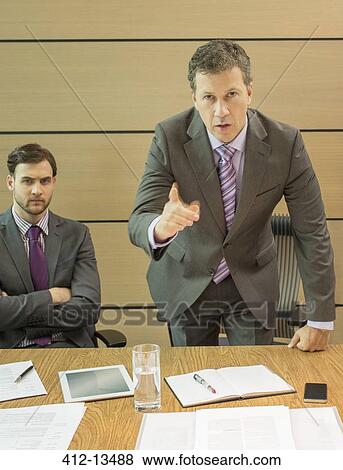 Stock Photo - Businessman shaking his finger in meeting. Fotosearch
