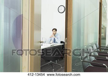 Businessman sitting in office View Large Photo Image Picture - Businessman sitting in office. Fotosearch